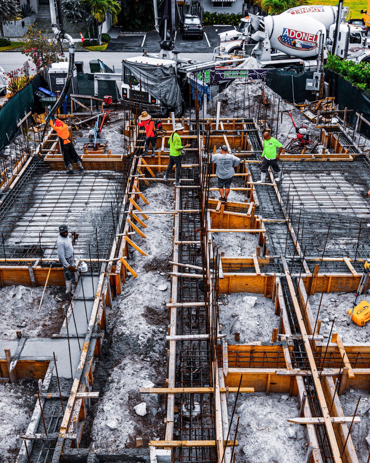 Crew pouring the foundation of a residential spec project