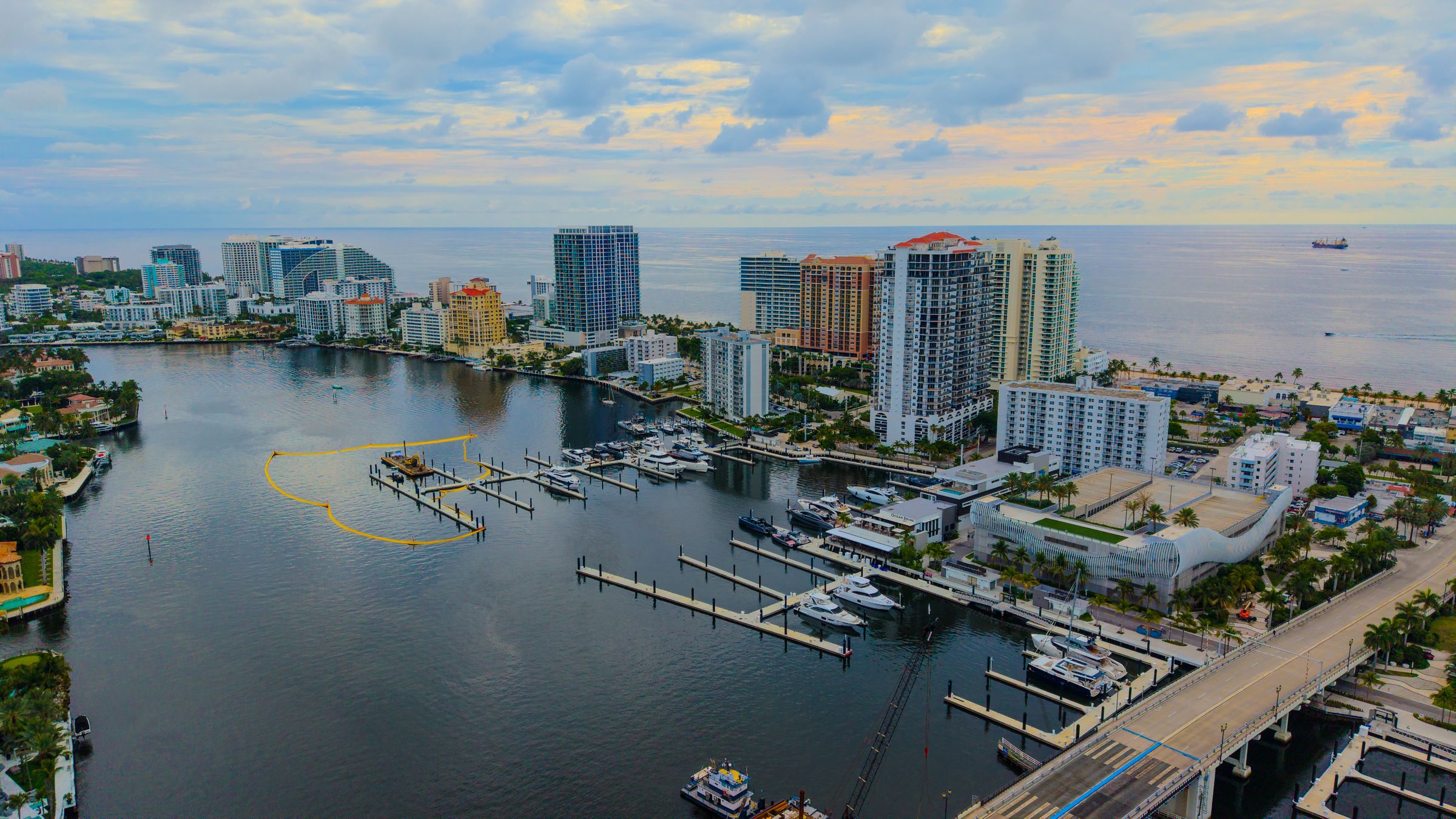 Fort Lauderdale marina and bridge on the Intracoastal Waterway, with the beach towers beyond